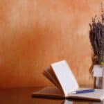 Pen and open planner on table with dried flowers, cremation service St. Louis, MO